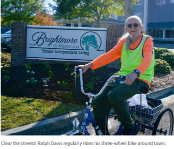 Brightmore of Wilmington's senior living community resident on a three-wheeled bike